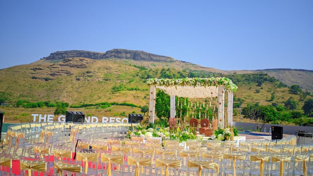 Outdoor mandap wedding ceremony with Sahyadri mountain backdrop at GG Resort